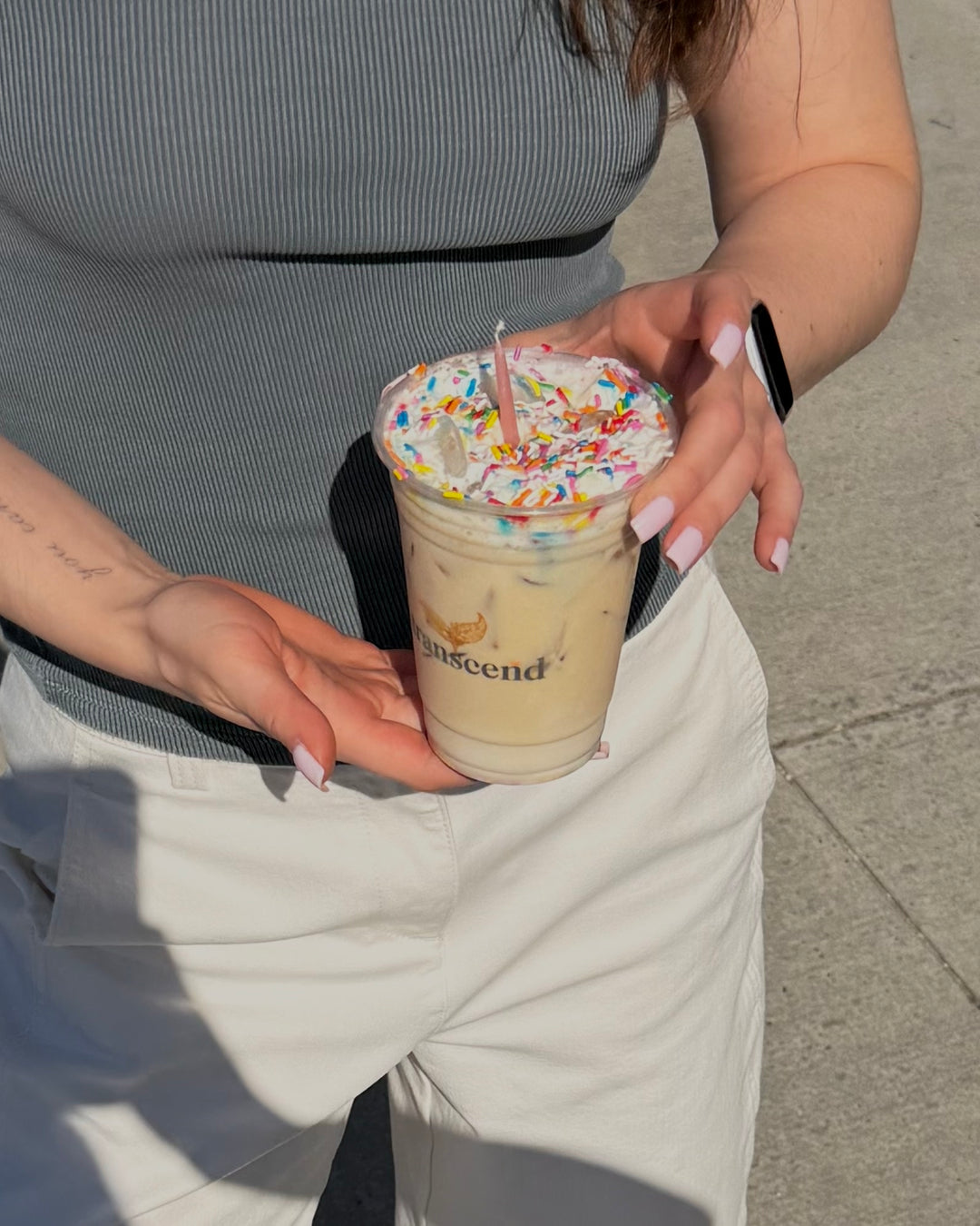 Woman holding a birthday cake latte
